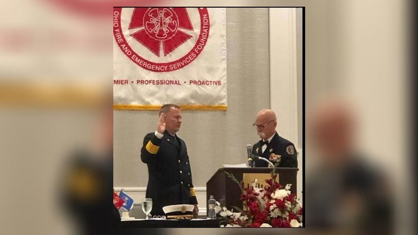 Franklin Fire Chief Jonathan Westendorf, left, takes the oath of office on July 14 as incoming president of the Ohio Fire Chiefs Association from outgoing president Mark Martin, fire chief of the Perry Twp. Fire Department in Stark County. CONTRIBUTED