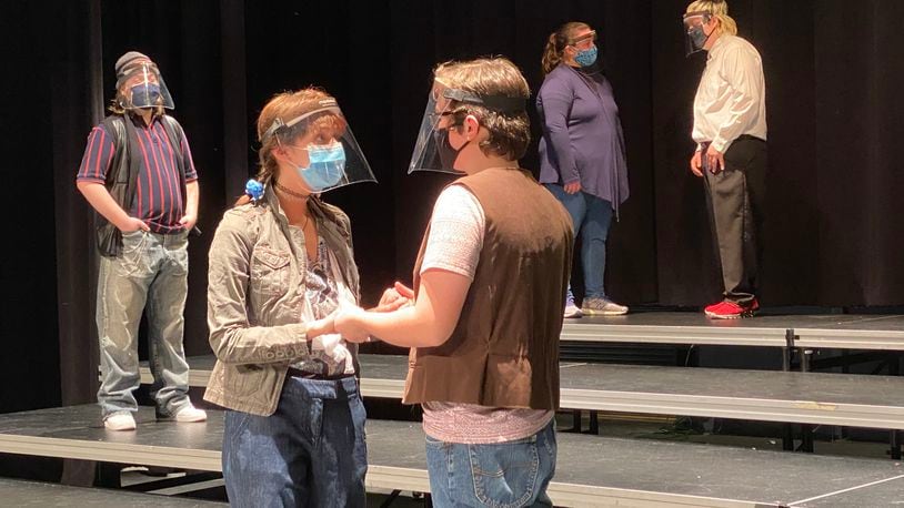 Across the region high school theater departments aren't letting a global pandemic stop their performances. Students are adjusting, say school officials, by adopting coronavirus preventive measures including masks, face shields and lots of hand sanitizer. Instead of live audiences, schools are beaming plays out over the internet. Pictured is Hamilton High School's rehearsal for Romeo & Juliet. (Provided Photo\Journal-News)